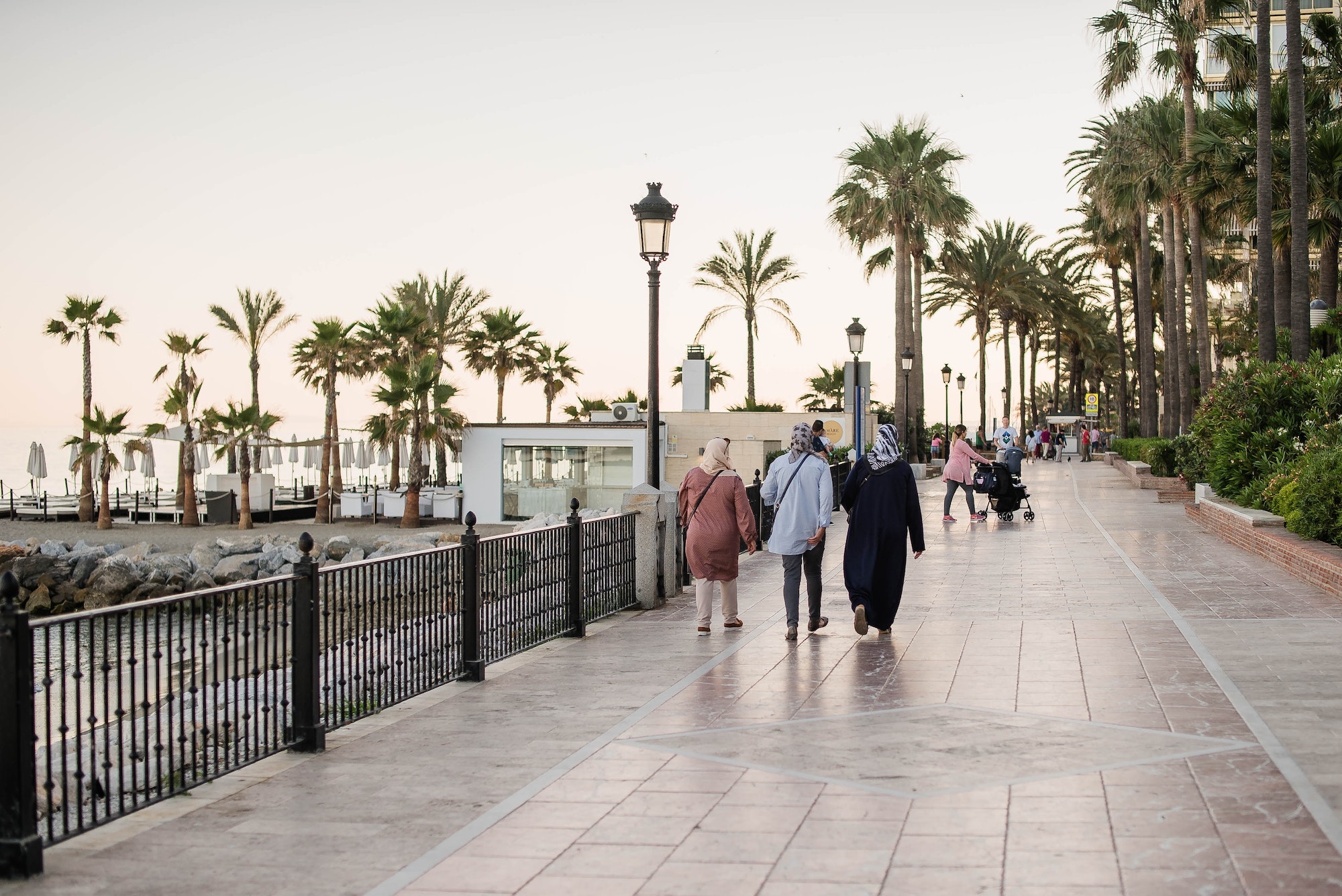 Spain . Marbella. People walk on the beach